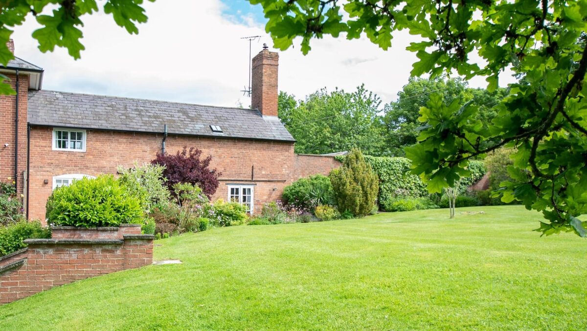 Exterior photo of holiday let with lawn to front