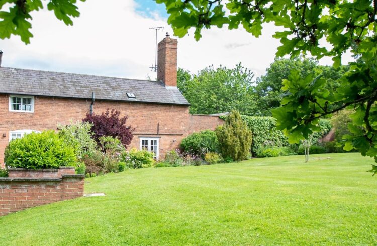 Exterior photo of holiday let with lawn to front